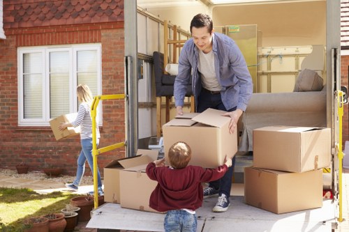 Helper carrying household items during a Westbrompton move