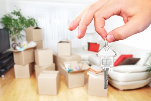 Staff using safe manual handling techniques during a house move