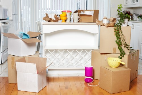 Packed moving boxes and furniture ready for collection in a Westbrompton home