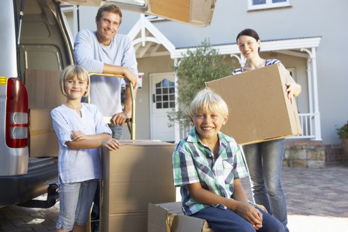 Trained movers using correct lifting techniques with protective gear